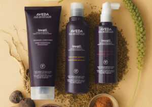 - Marion Salon Spa in Salt Point, NY Three Aveda Invati thickening hair care products, including conditioner, shampoo, and scalp treatment, displayed among grains and botanical ingredients. - Marion Salon Spa in Salt Point, NY