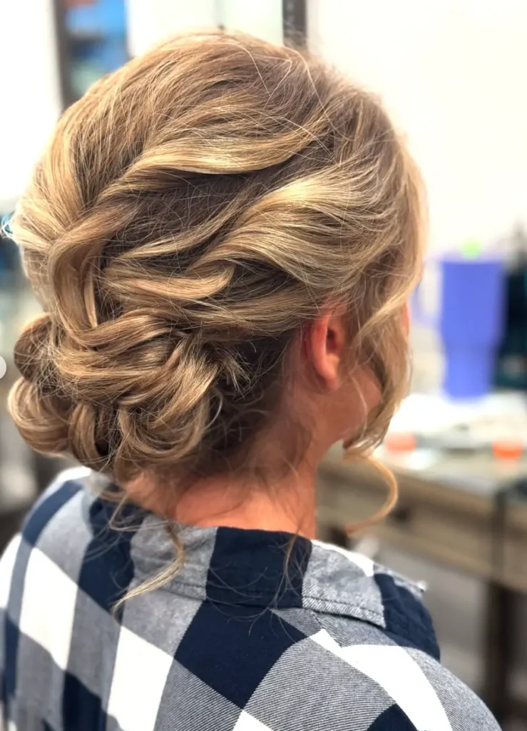 - Marion Salon Spa in Salt Point, NY Overhead close-up of an elegant, tousled updo in warm honey-blonde tones, showcasing the smooth, polished finish achieved with hand-tied hair extensions. - Marion Salon Spa in Salt Point, NY